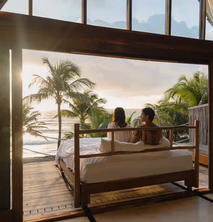 Iconic hotel room with a sliding bed moving towards the terrace facing the beach at La Valise Tulum Hotel.