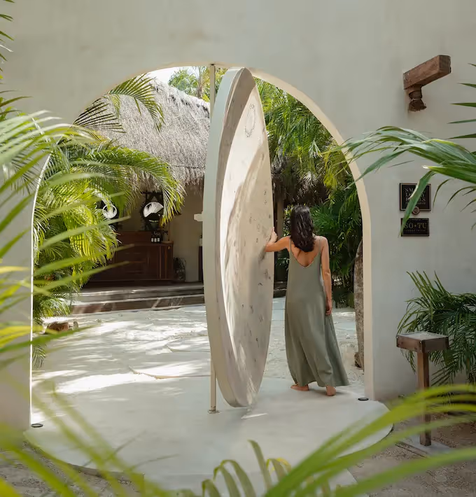 Minimalist design and iconic circular pivoting door at the entrance of La Valise Tulum Hotel.