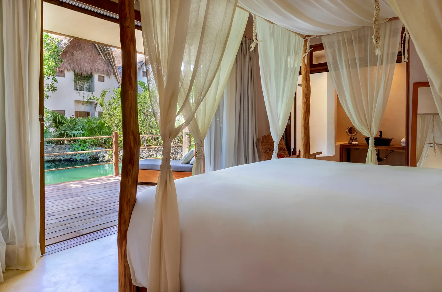 King bed looking out over the cenote — Jaguar Suite, La Valise Tulum
