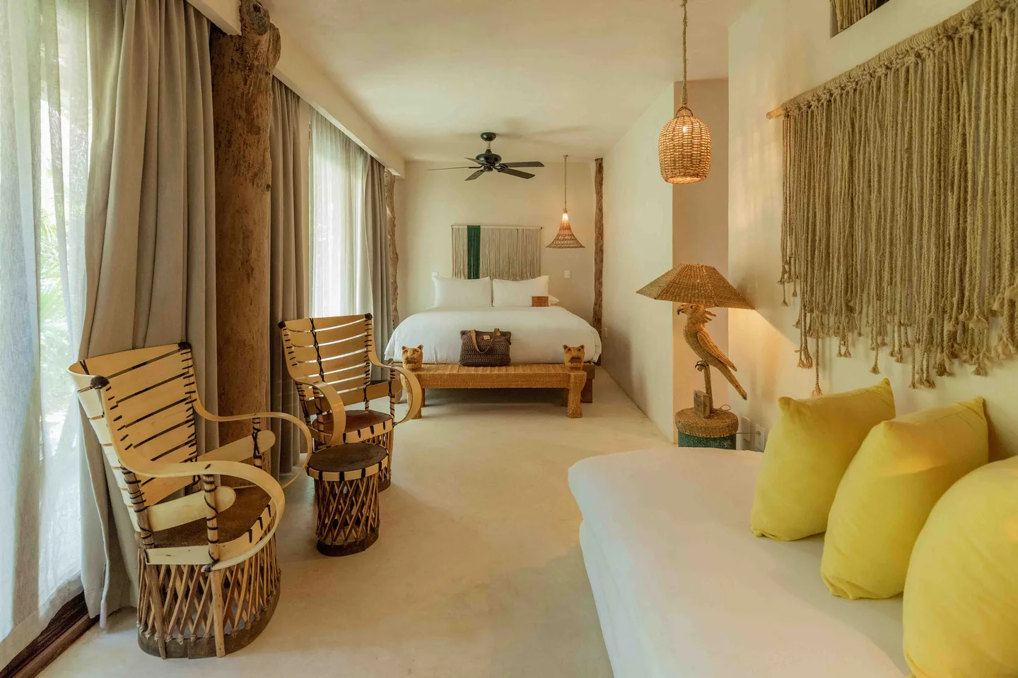 Garden Suite interior with lounge and king bed — Rattan Suite, La Valise Tulum