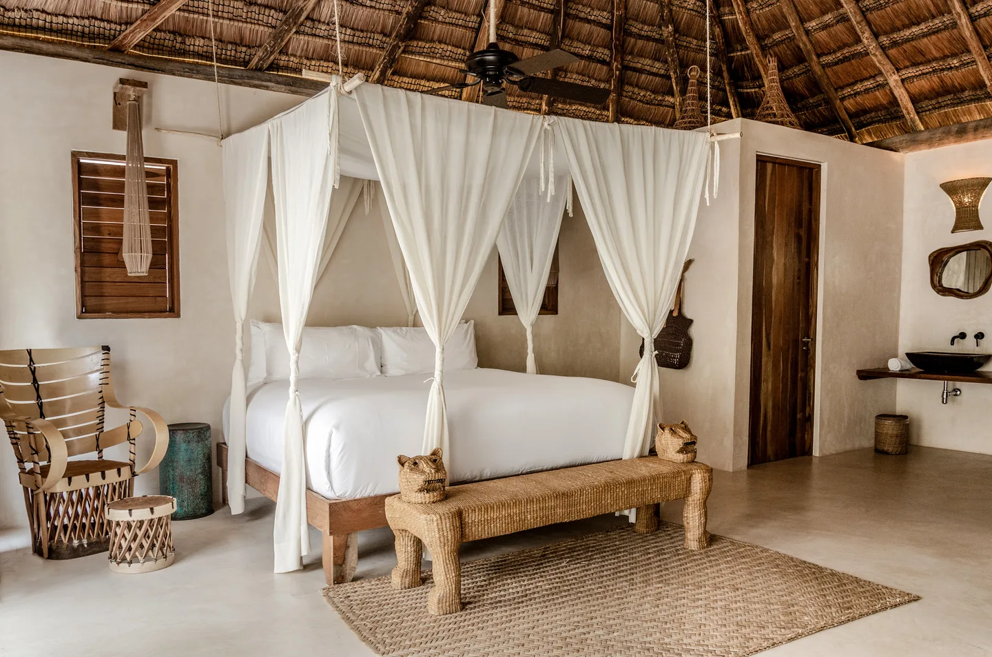 Canopied king bed under the palapa roof — Horizon Suite, La Valise Tulum
