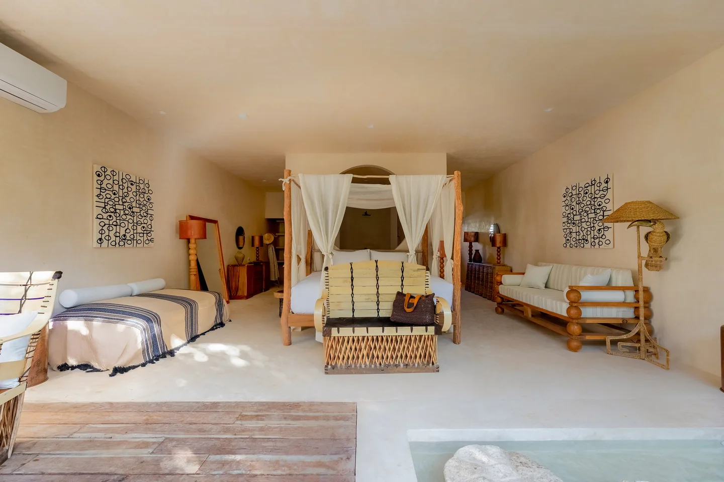 Signature Suite interior with canopied king bed and lounge — Mangrove Suite, La Valise Tulum